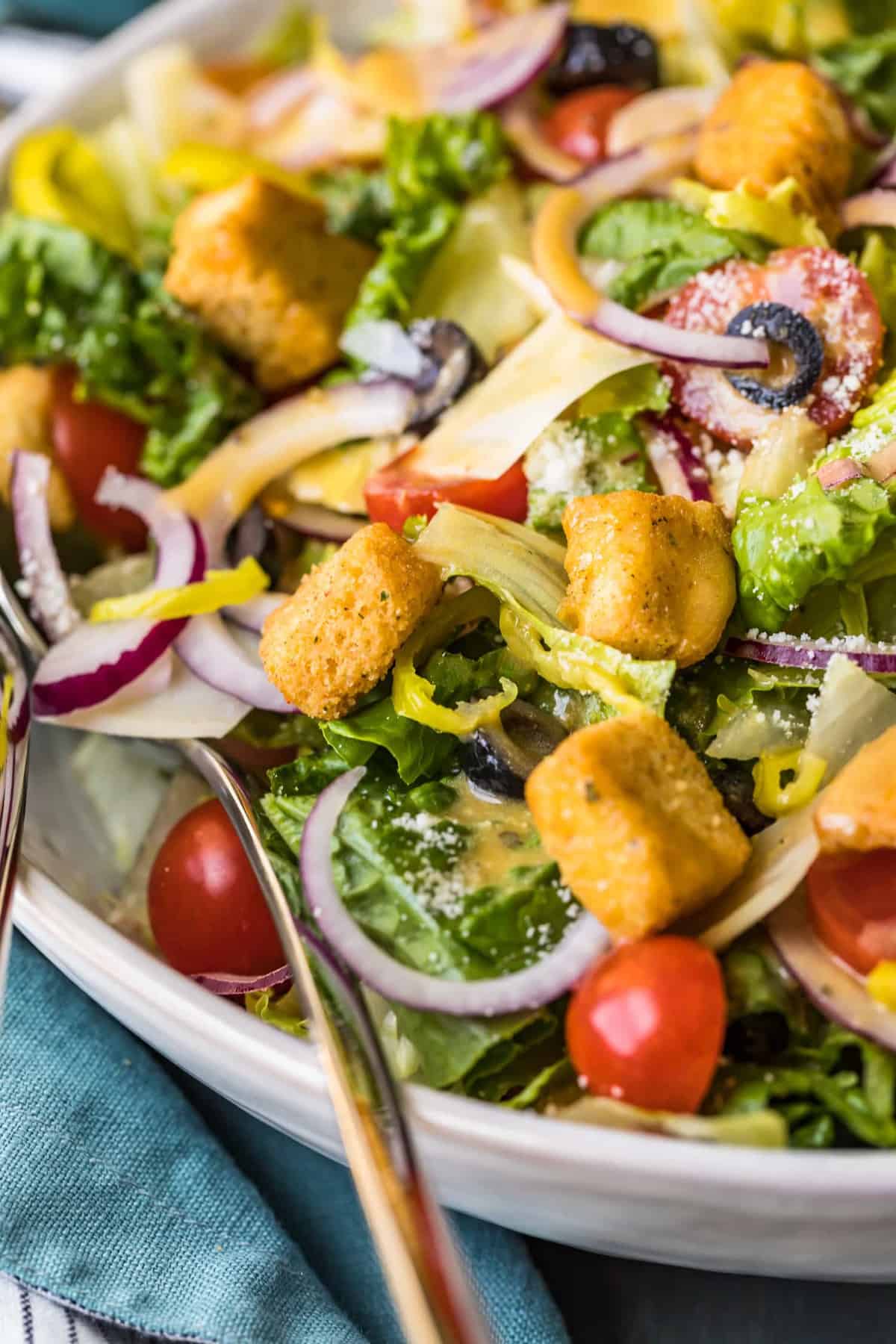 A serving spoon in the Olive Garden salad