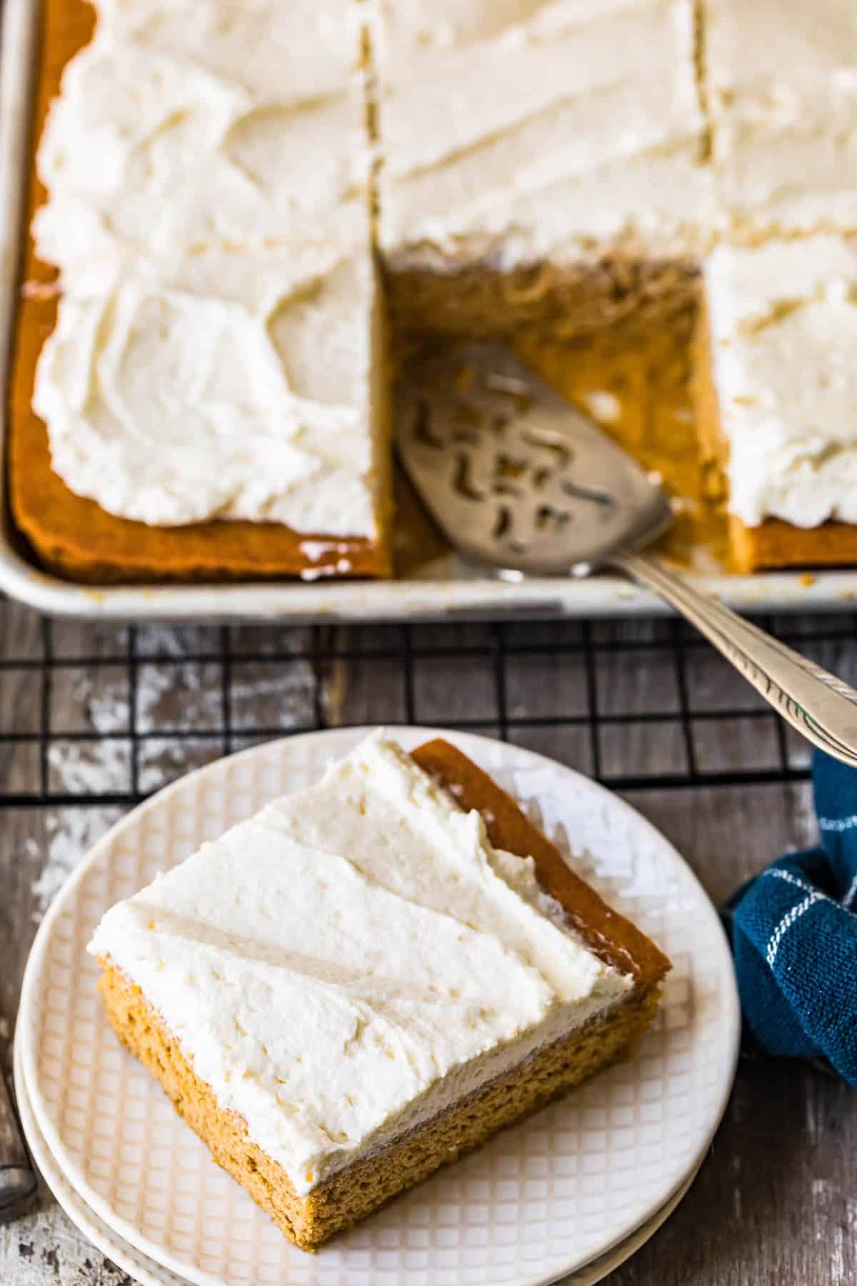 A square pumpkin bar removed from the sheet pan and served on a plate