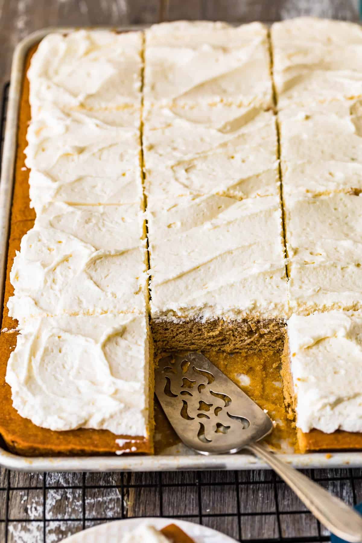 A pumpkin bar removed from the sheet pan cake