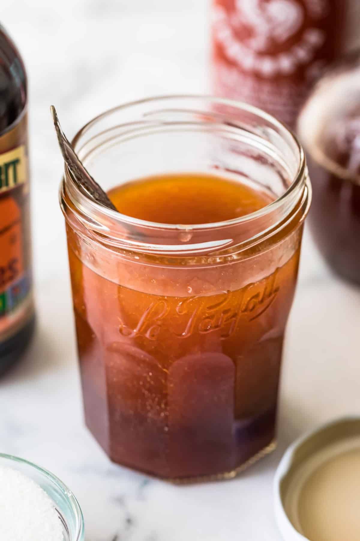 Spicy Sweet Salad Dressing in a jar with a spoon ready to serve