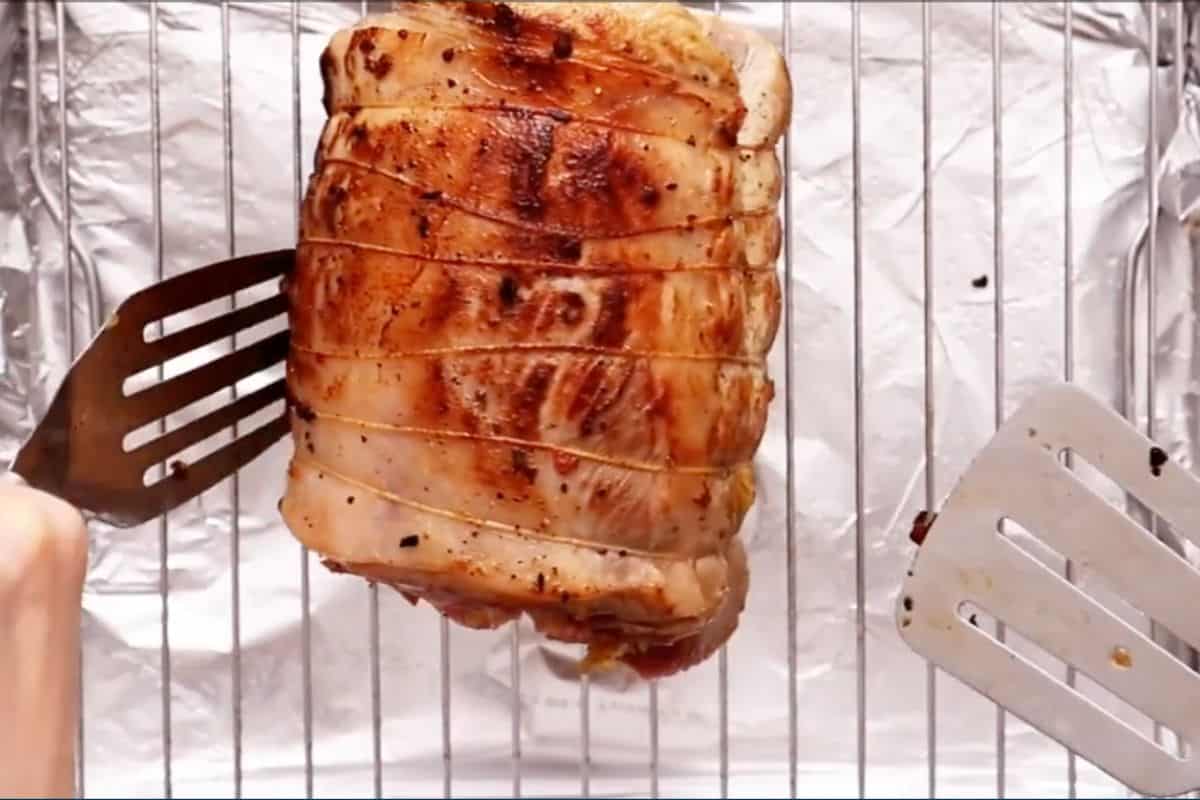 place the stove-top roasted pork roulade on the baking sheet