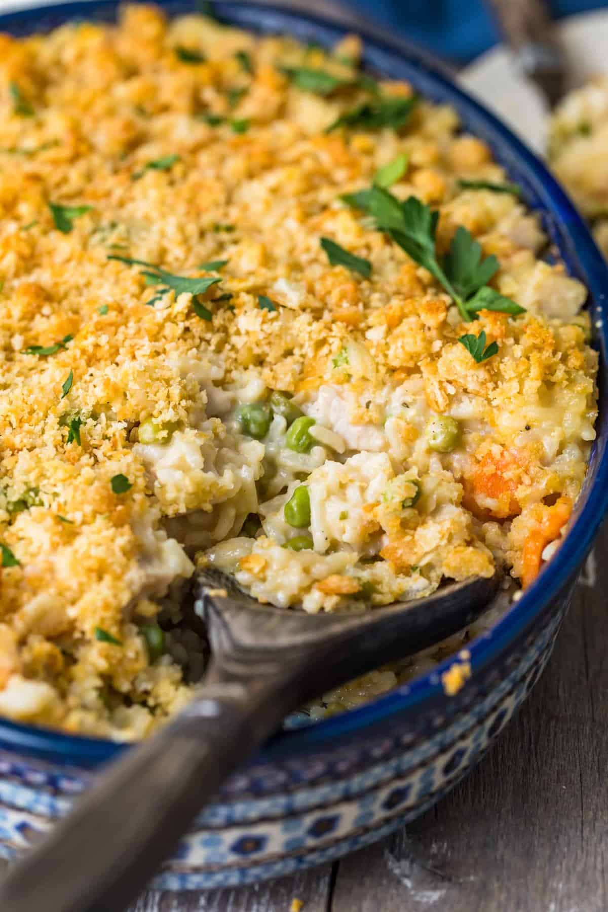 Turkey Rice Casserole in a blue casserole dish with a wooden spoon