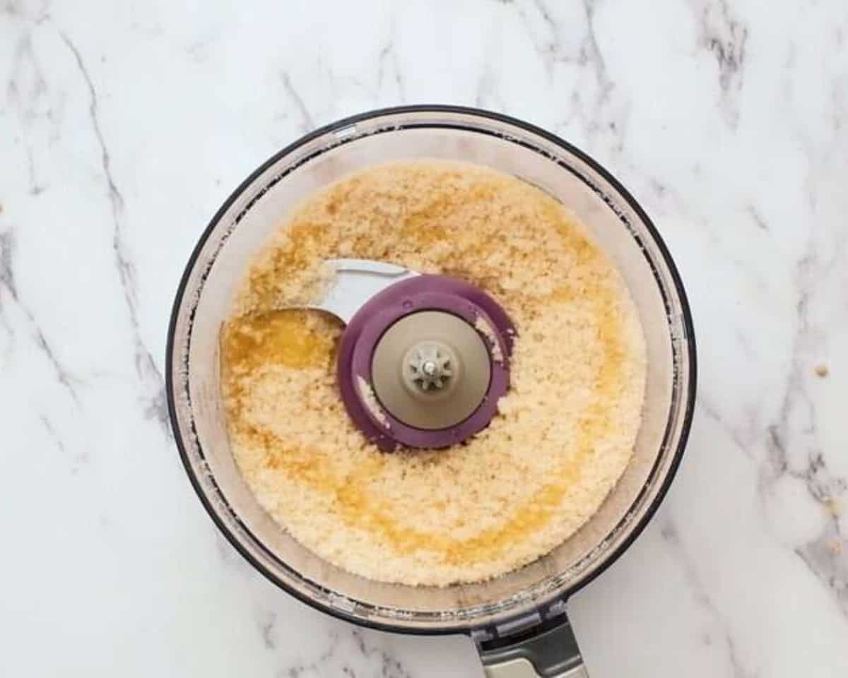 Processing bread, breadcrumbs, and Parmesan in the food processor.