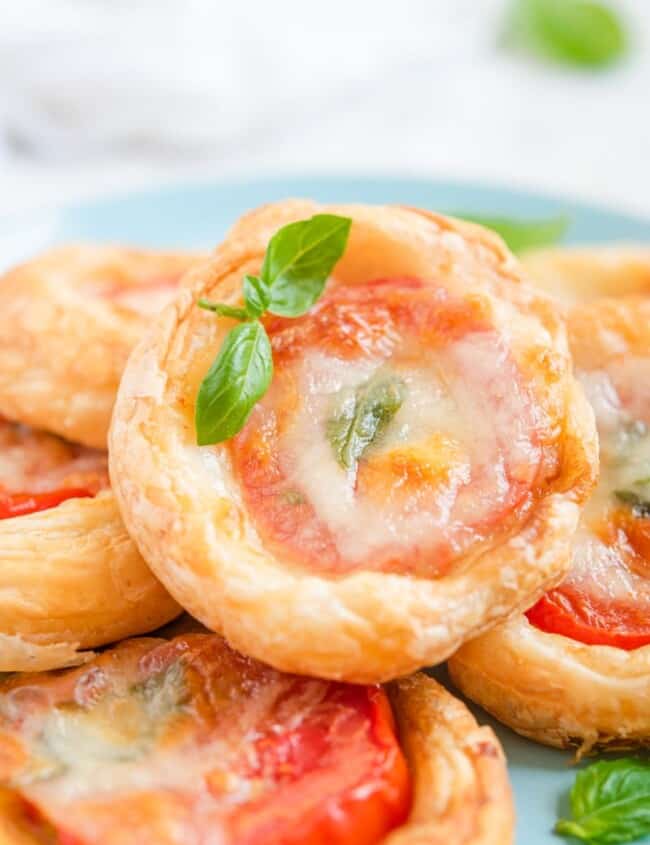caprese tarts stacked on a plate
