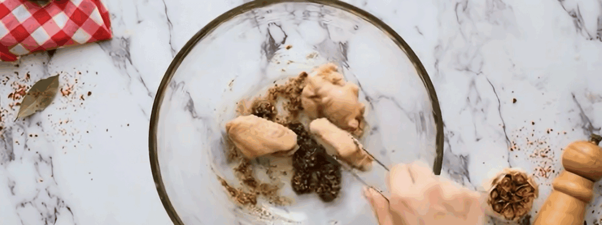 Coating the chicken with the seasoned breading.