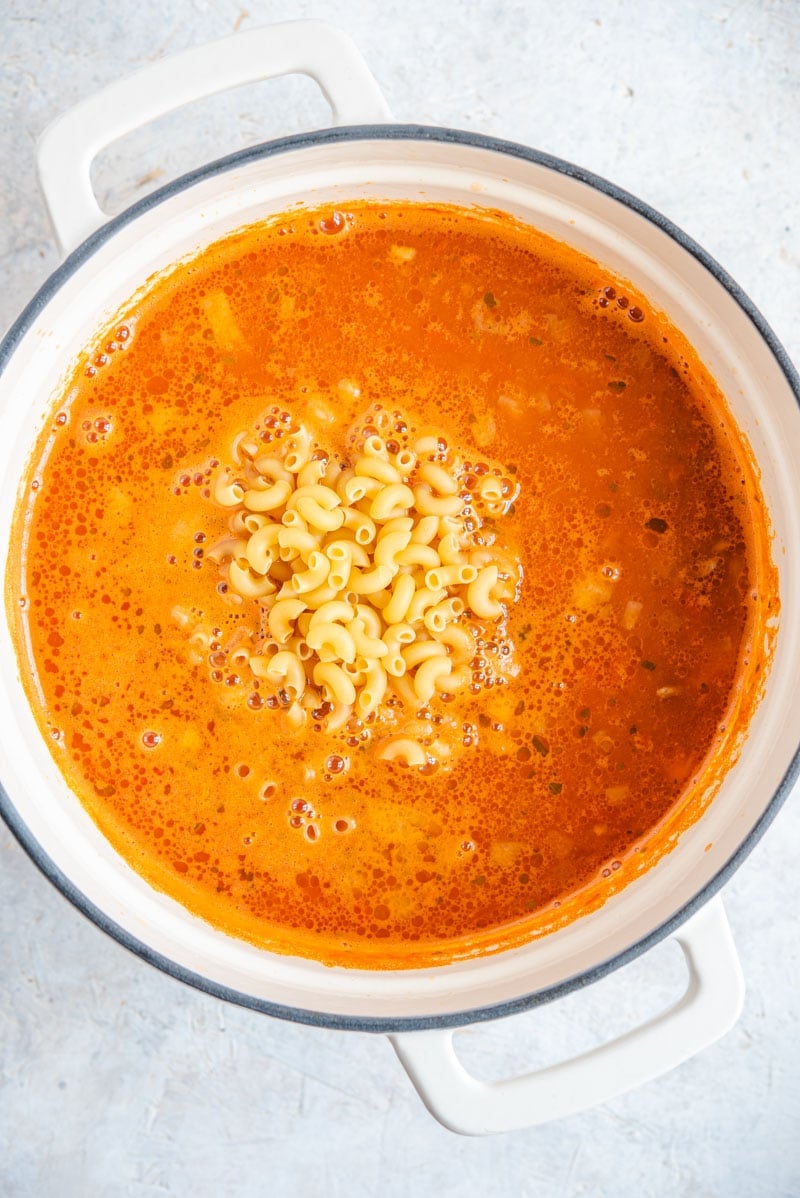 An overhead shot of macaroni mixed with beef chili.