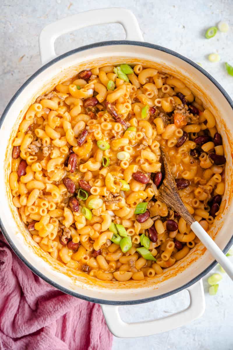 An overhead shot of chili mac and cheese in a large pot.