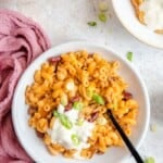 loaded chili mac and cheese in a white bowl