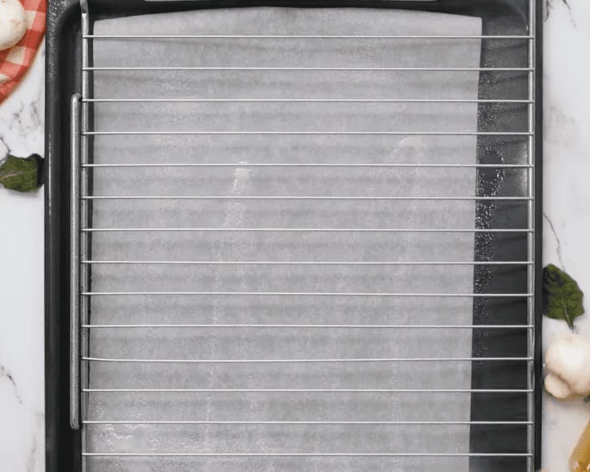 Baking tray with parchment paper and a rack.