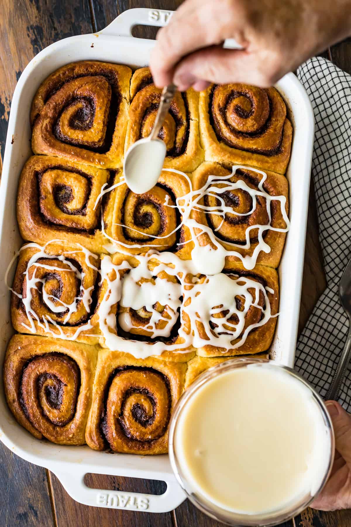 Drizzling icing on the baked rolls