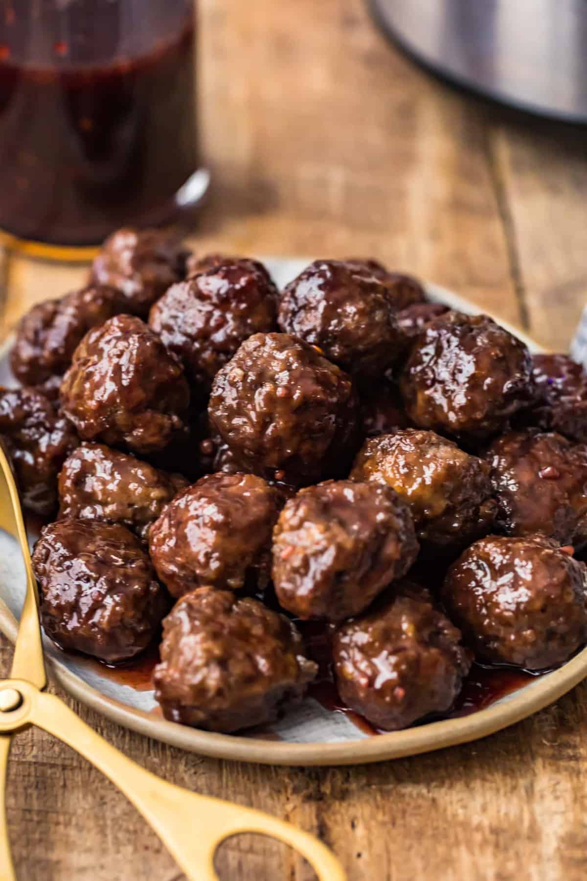 Grape Jelly Meatballs on a serving plate on a work top