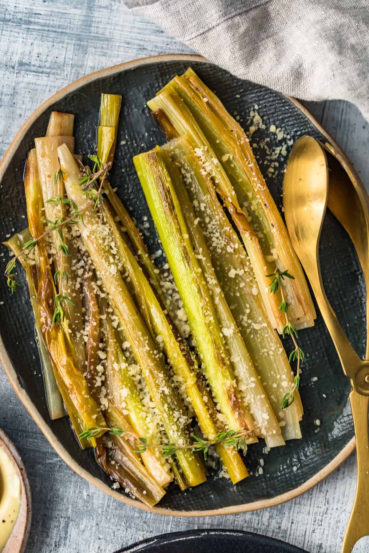 Close up of the sauteed leeks on a black plate