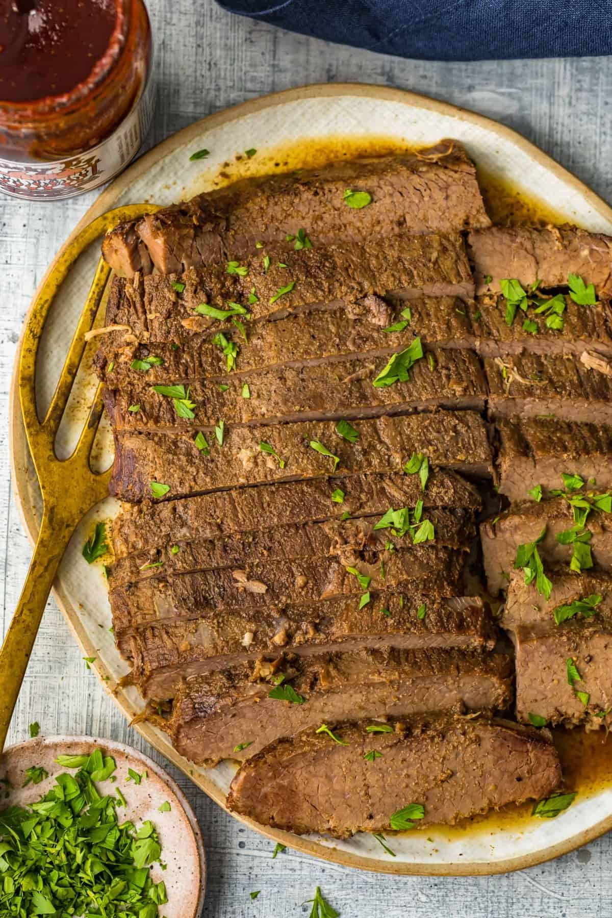 Slow Cooker Brisket garnished with fresh herbs