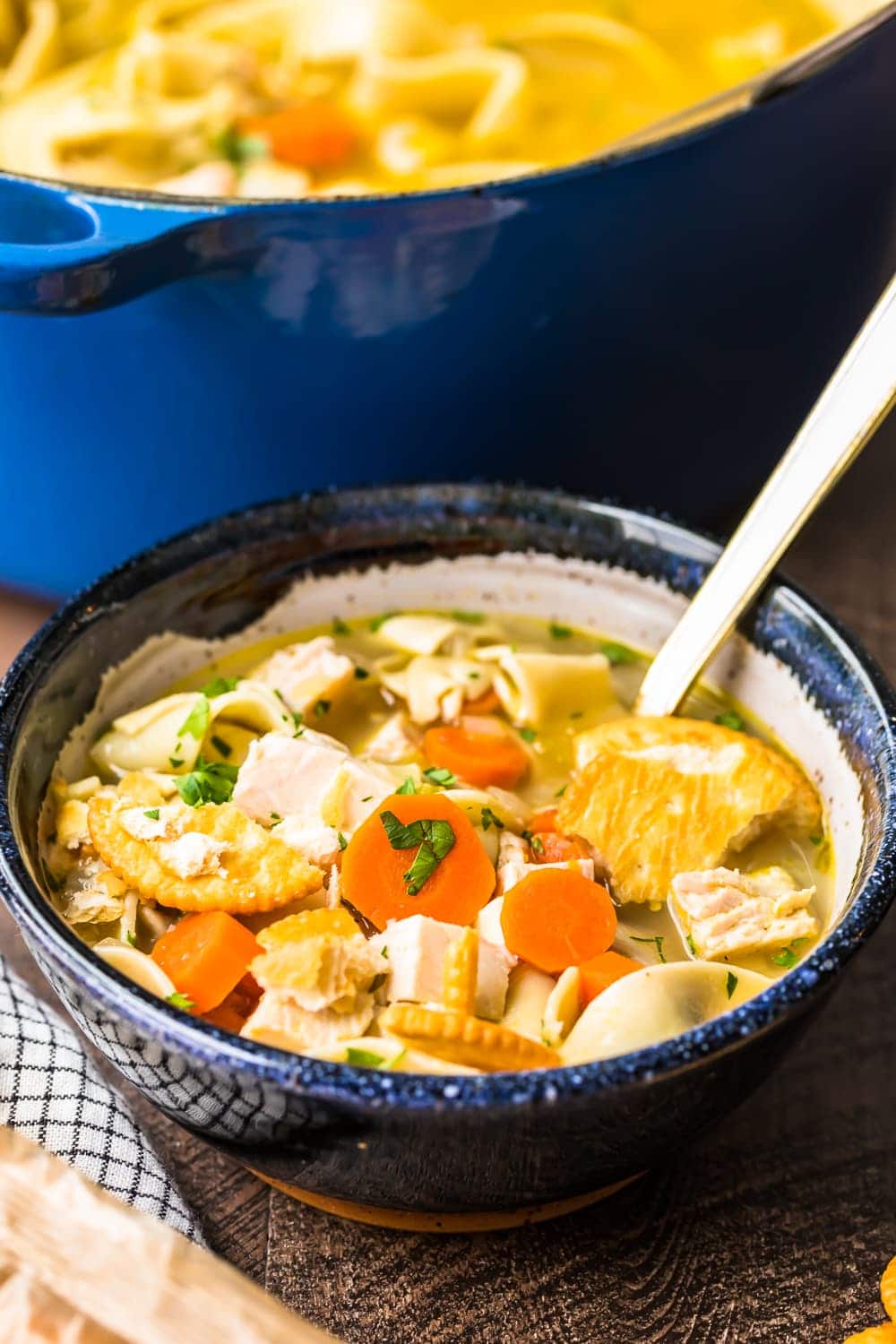 Soup served in a dark bowl with a spoon