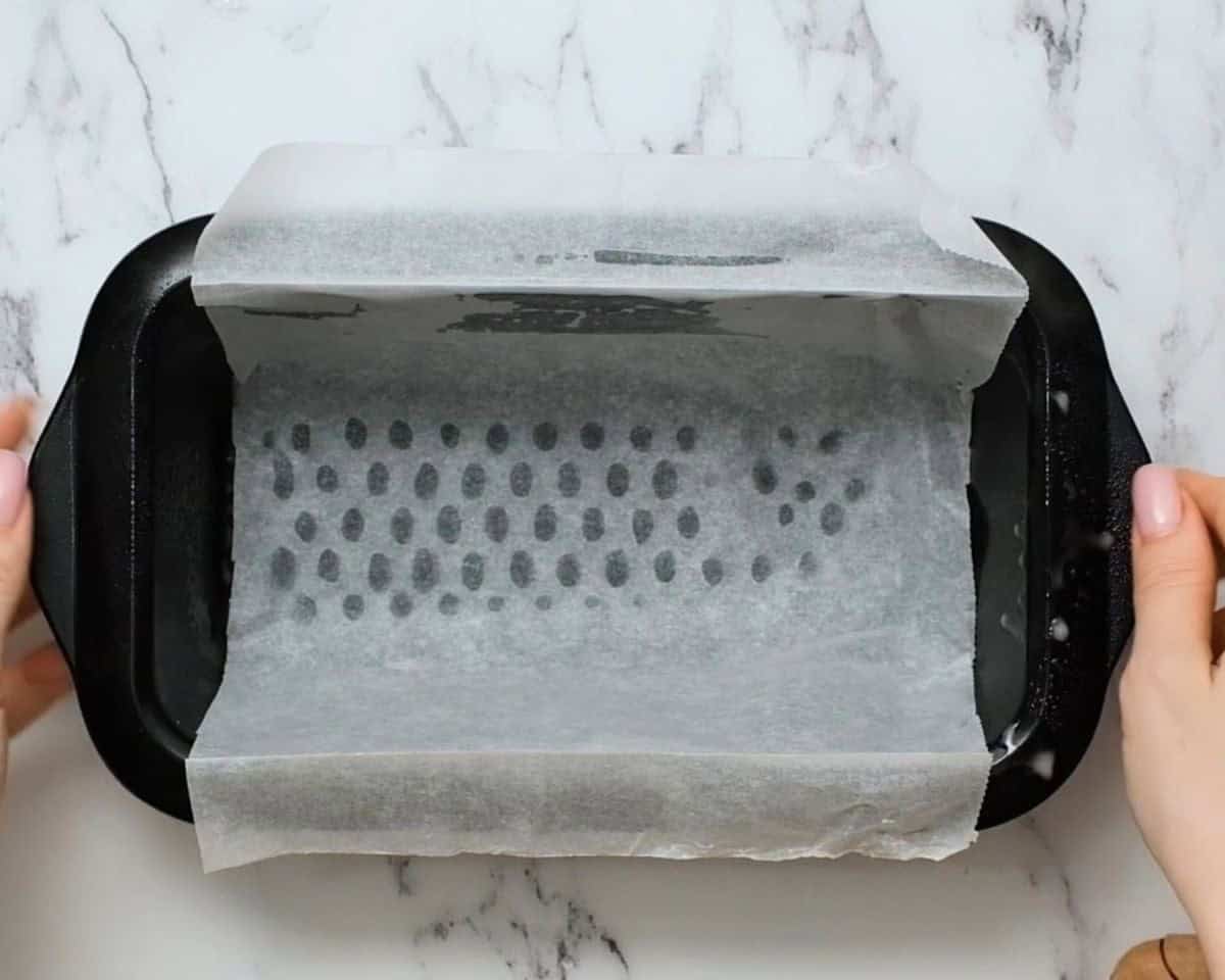 Sprayed loaf pan lined with parchment paper.
