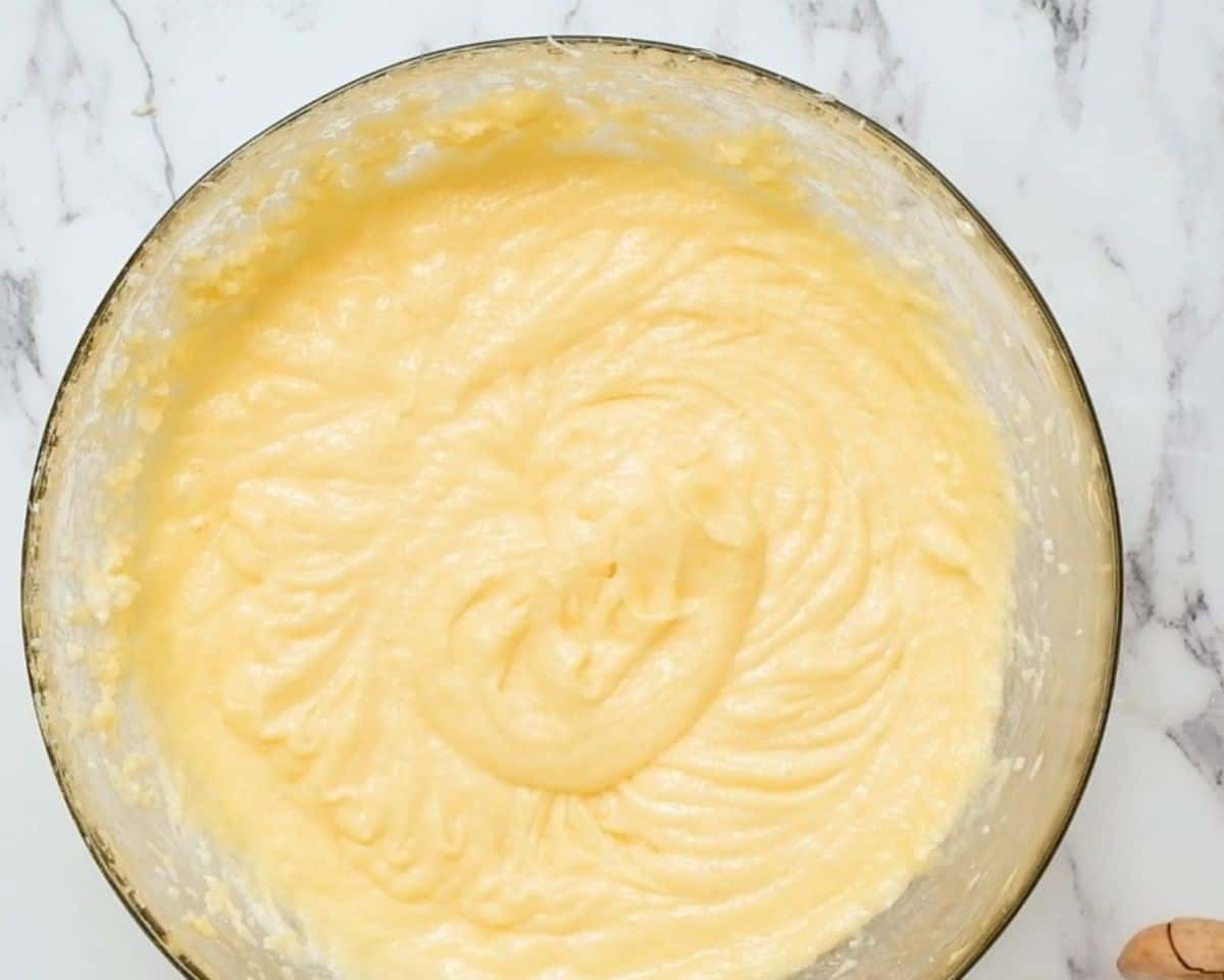 Adding eggs to the batter.
