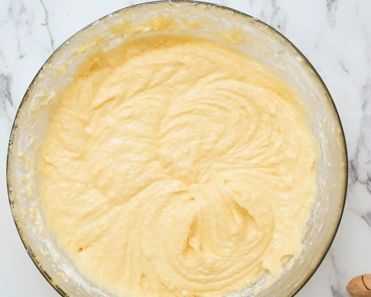 Combining the flour mixture with the sugar/egg mixture.
