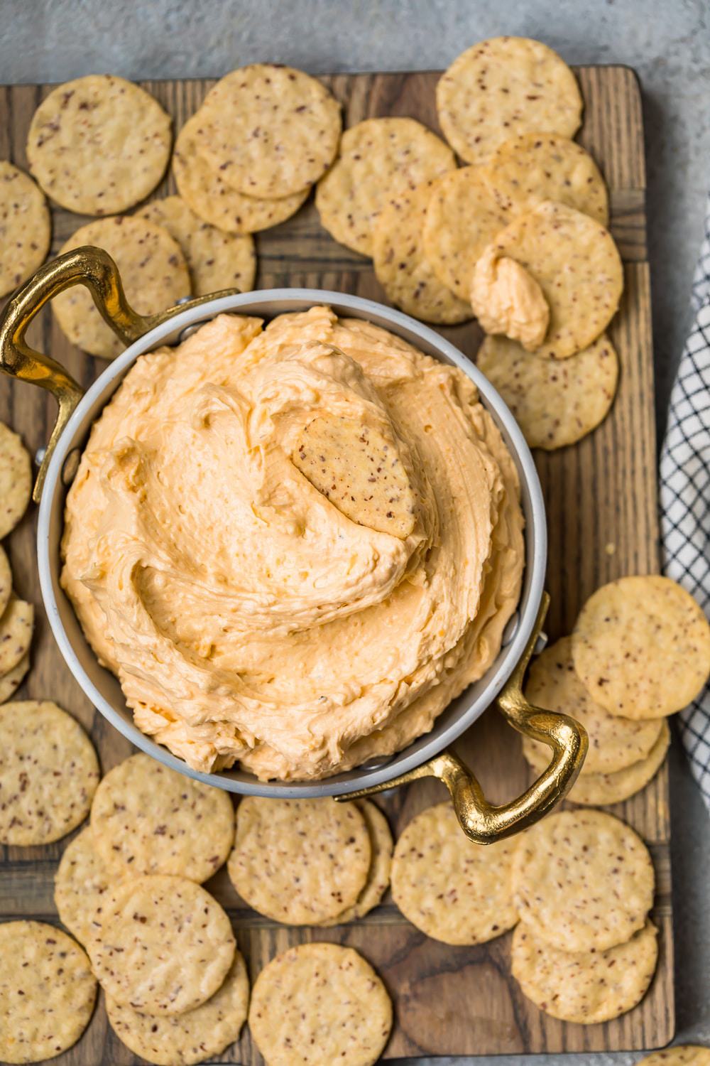 Beer Cheese Dip served in a bowl with piles of crackers