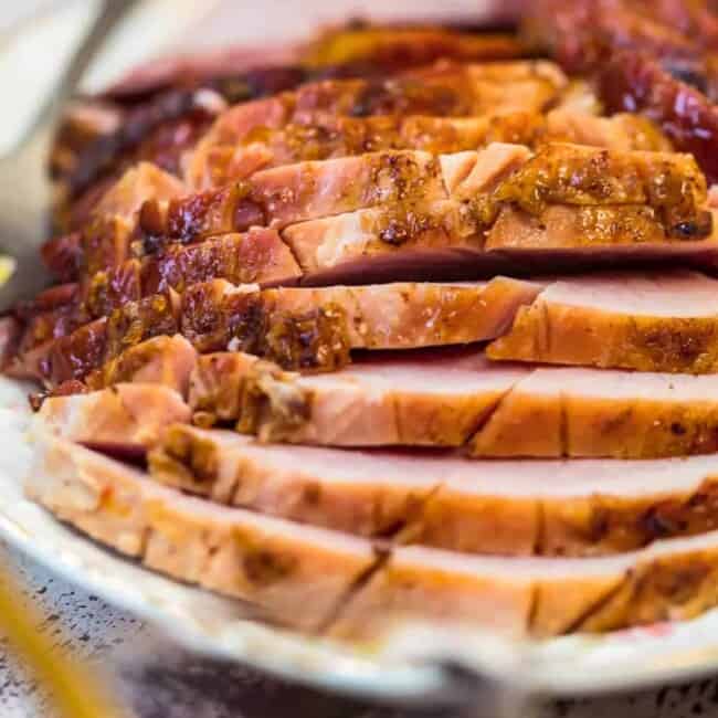 sliced marmalade glazed ham on a plate
