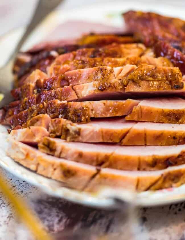 sliced marmalade glazed ham on a plate