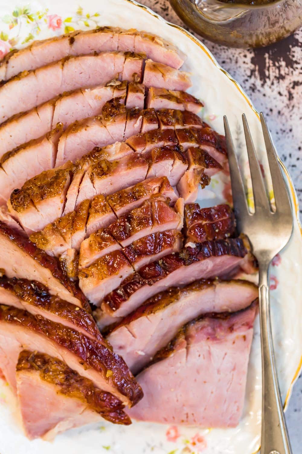 Marmalade Glazed Ham on a serving plate with a fork