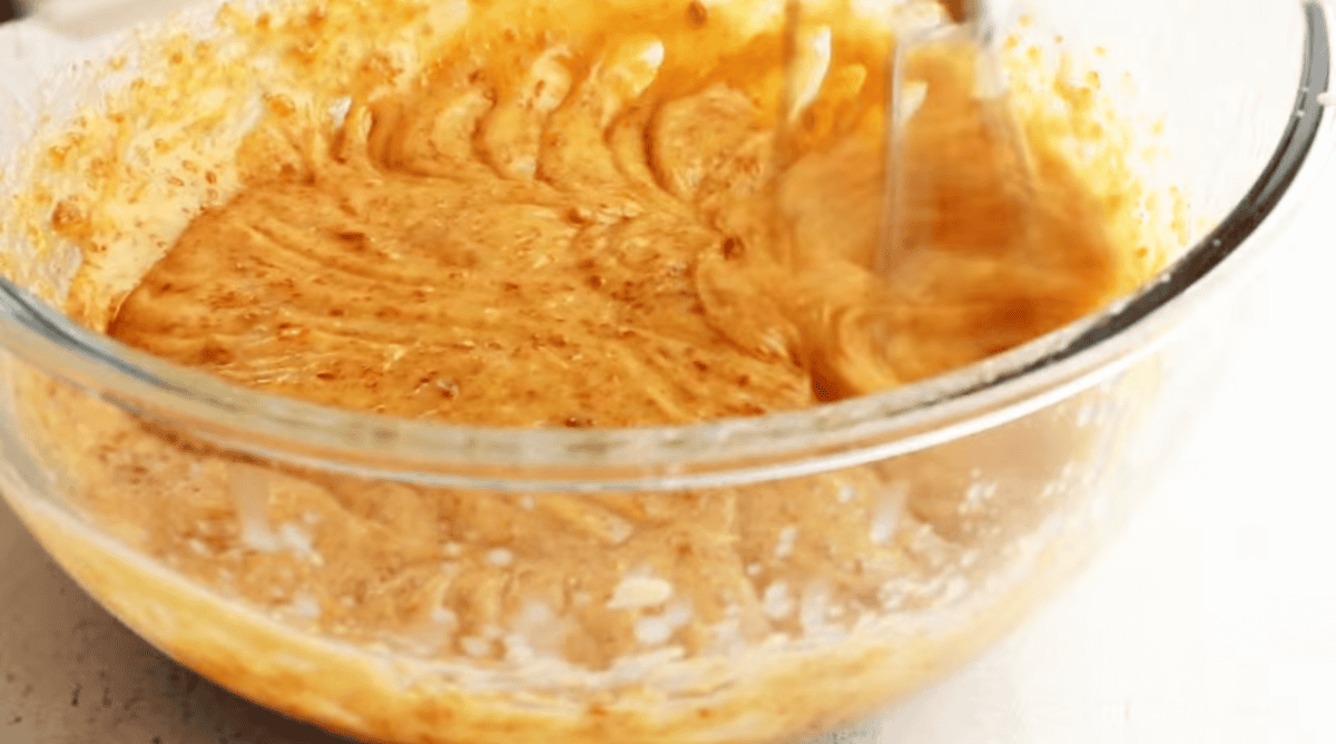 Adding eggs to the mixture.