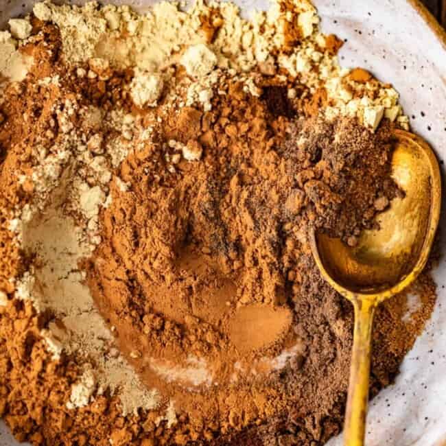 Chocolate powder sprinkled in a bowl with a spoon.