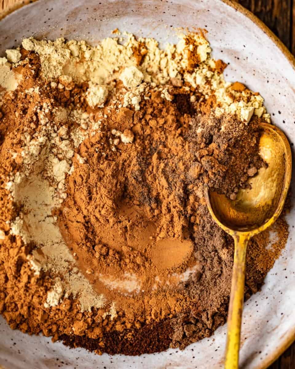 Chocolate powder sprinkled in a bowl with a spoon.