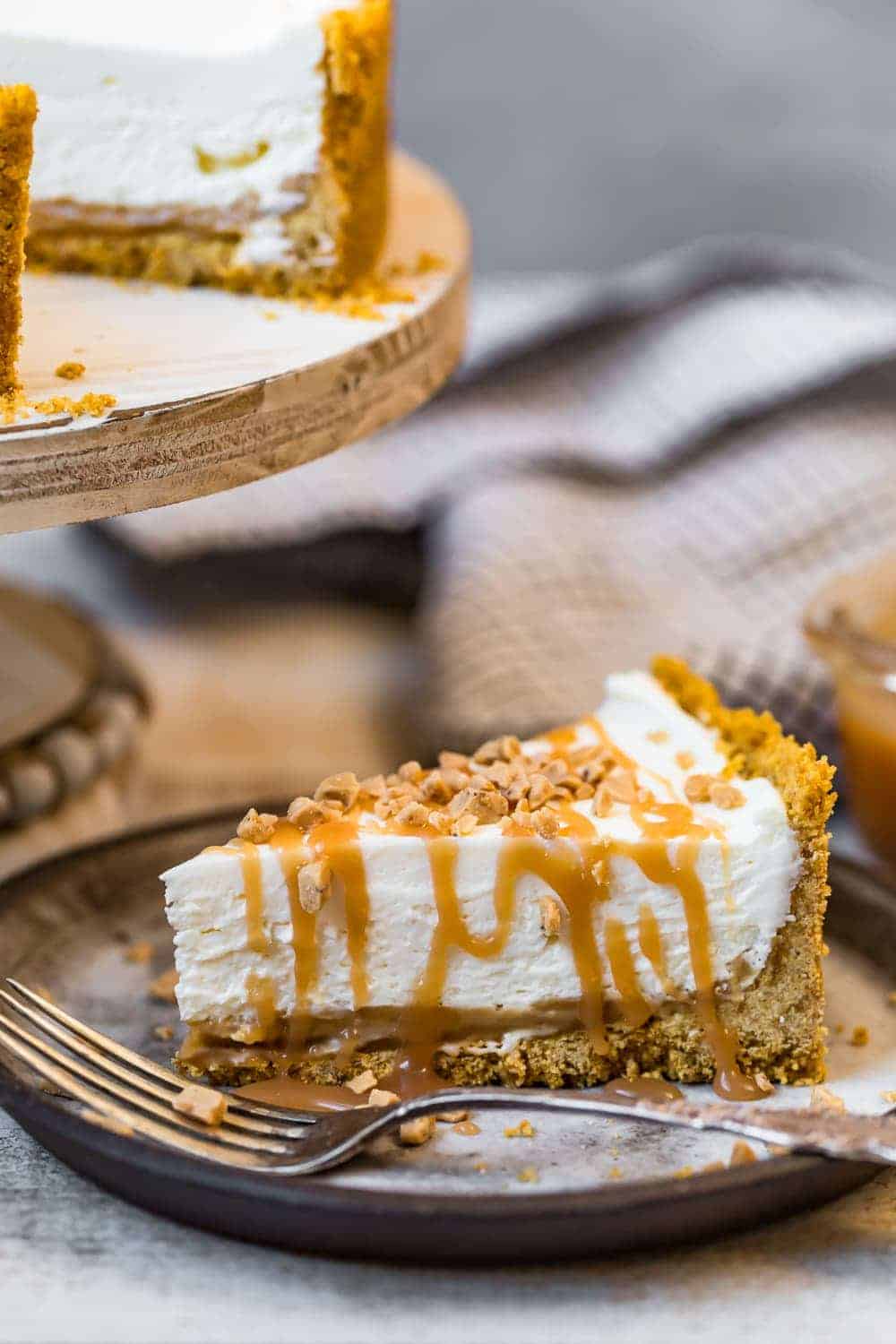 A slice of Salted Caramel No Bake Cheesecake served with a fork