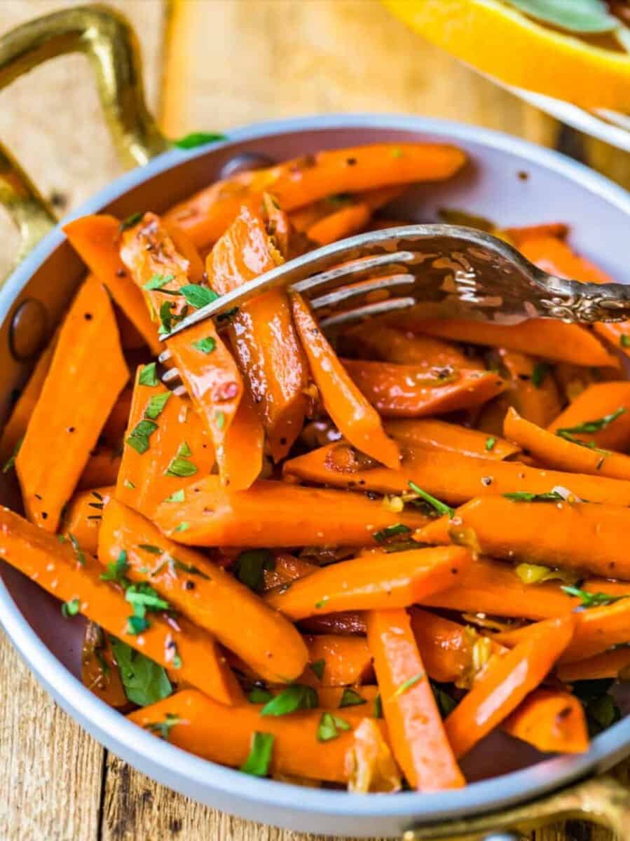 Sauteed carrots with a fork.