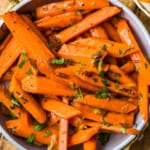 Sauteed carrots with thyme and oranges in a bowl.