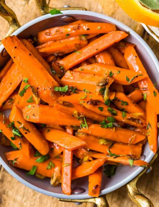 Sauteed carrots with thyme and oranges in a bowl.
