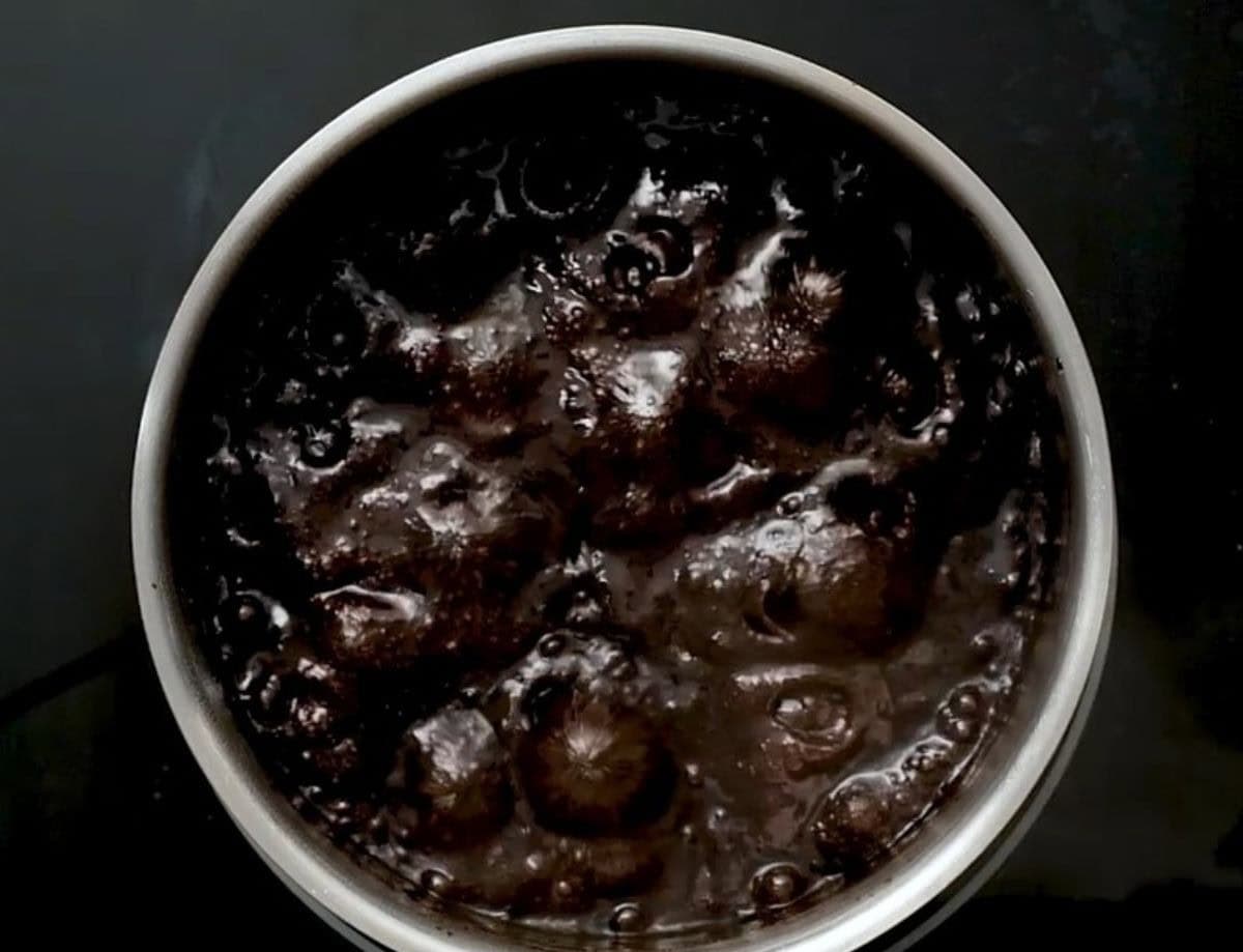 Cookie dough coming to a boil in a pot.