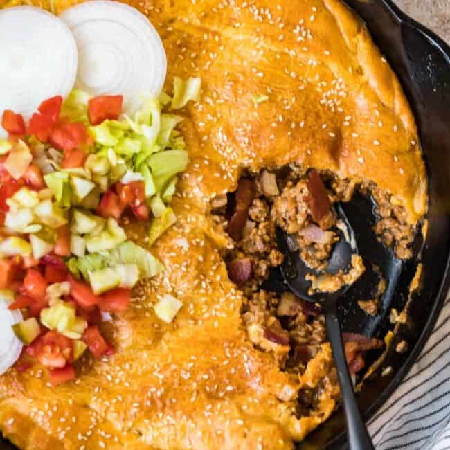 bacon cheeseburger pot pie in a skillet with spoon