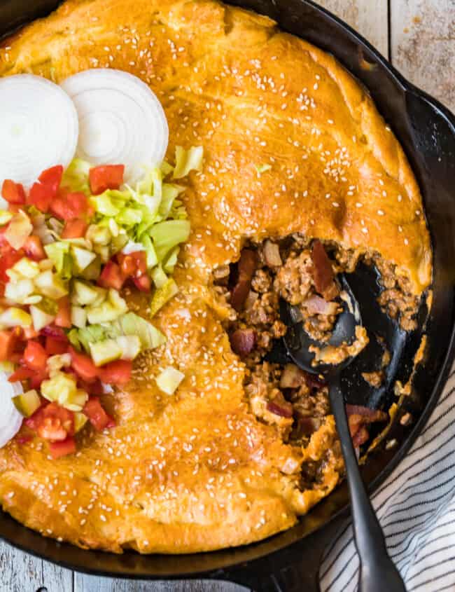 bacon cheeseburger pot pie in a skillet with spoon