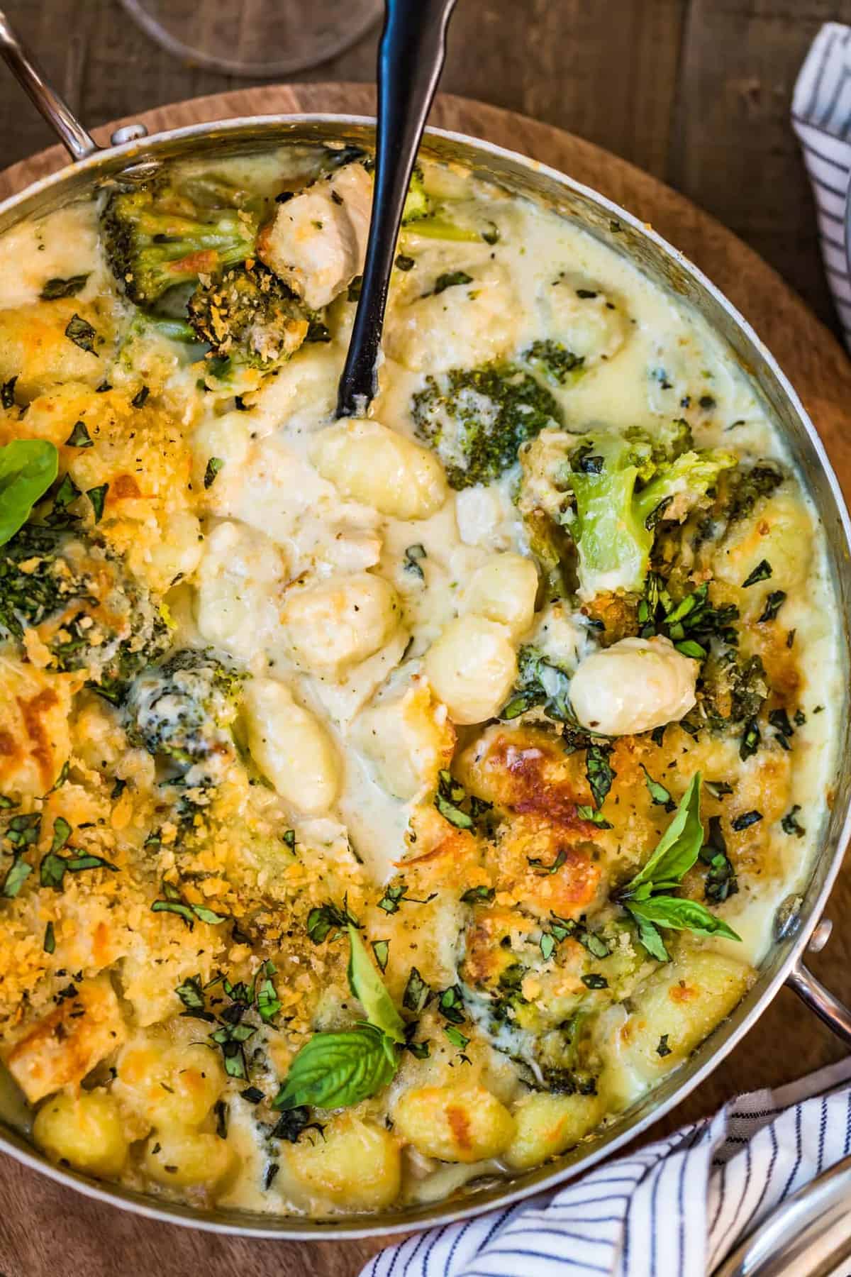 Close up shot of Chicken Alfredo Gnocchi Bake with spoon in pot