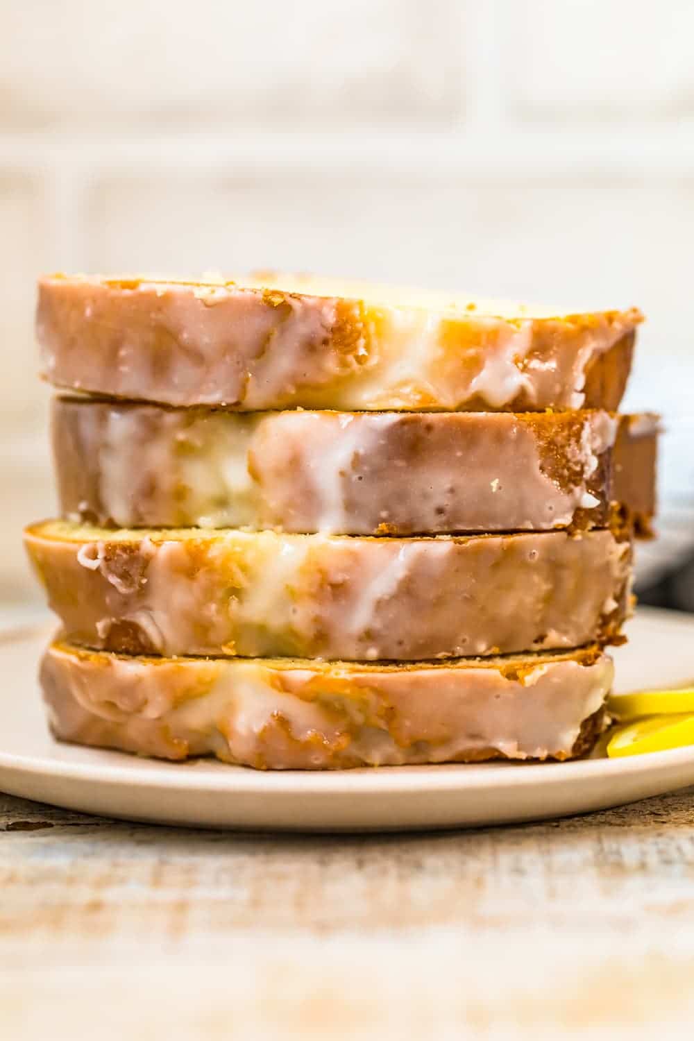 close up view of sliced iced lemon loaf cake 