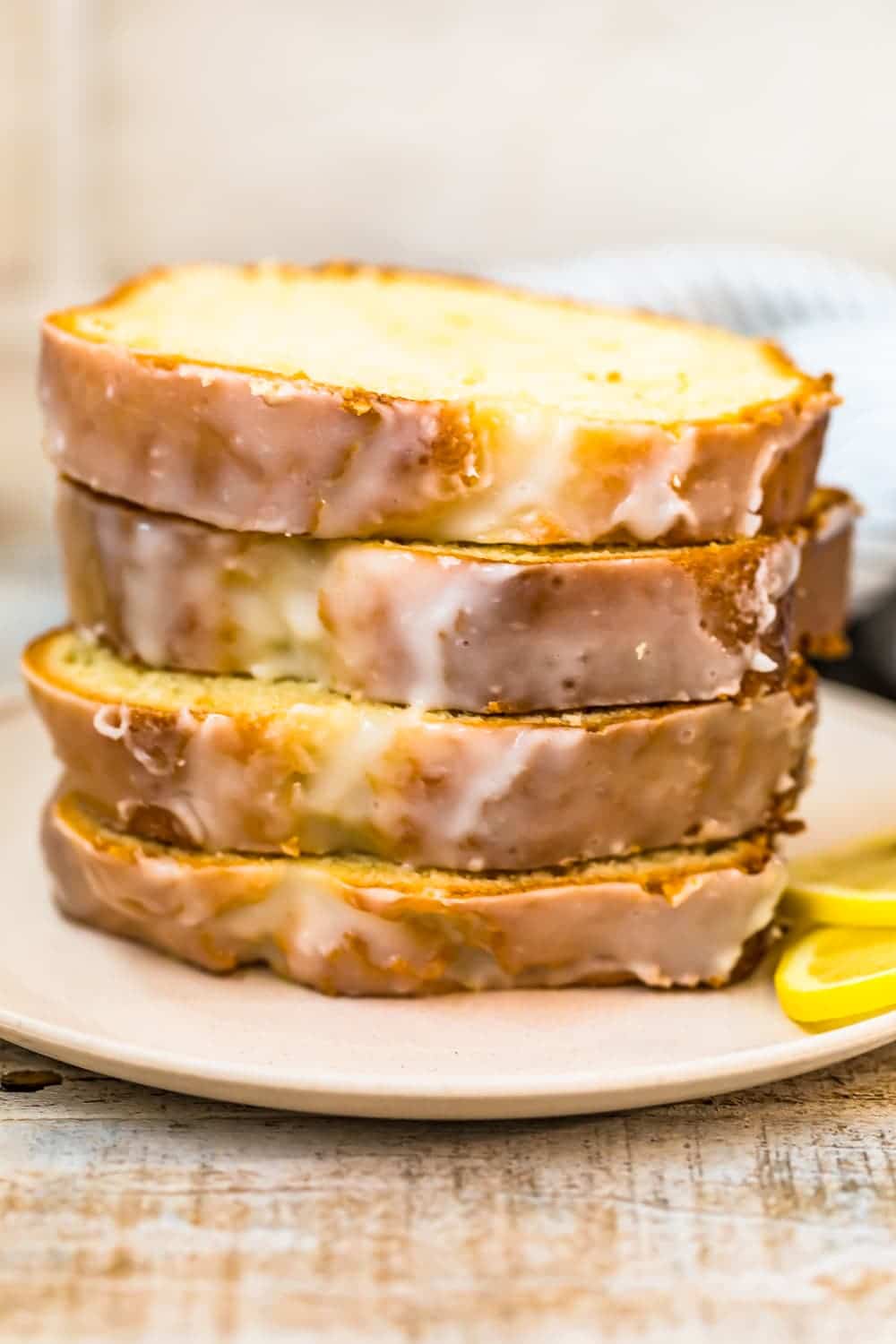 slices of iced lemon loaf cake on a plate