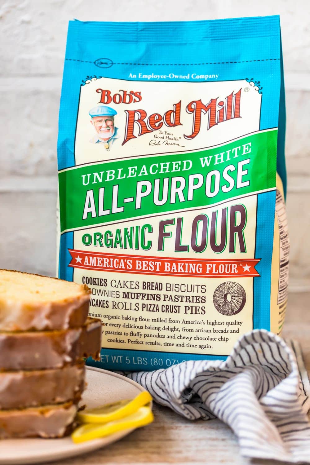 bob's red mill unbleached white all-purpose organic flour bag and a stack of bread slices on a plate