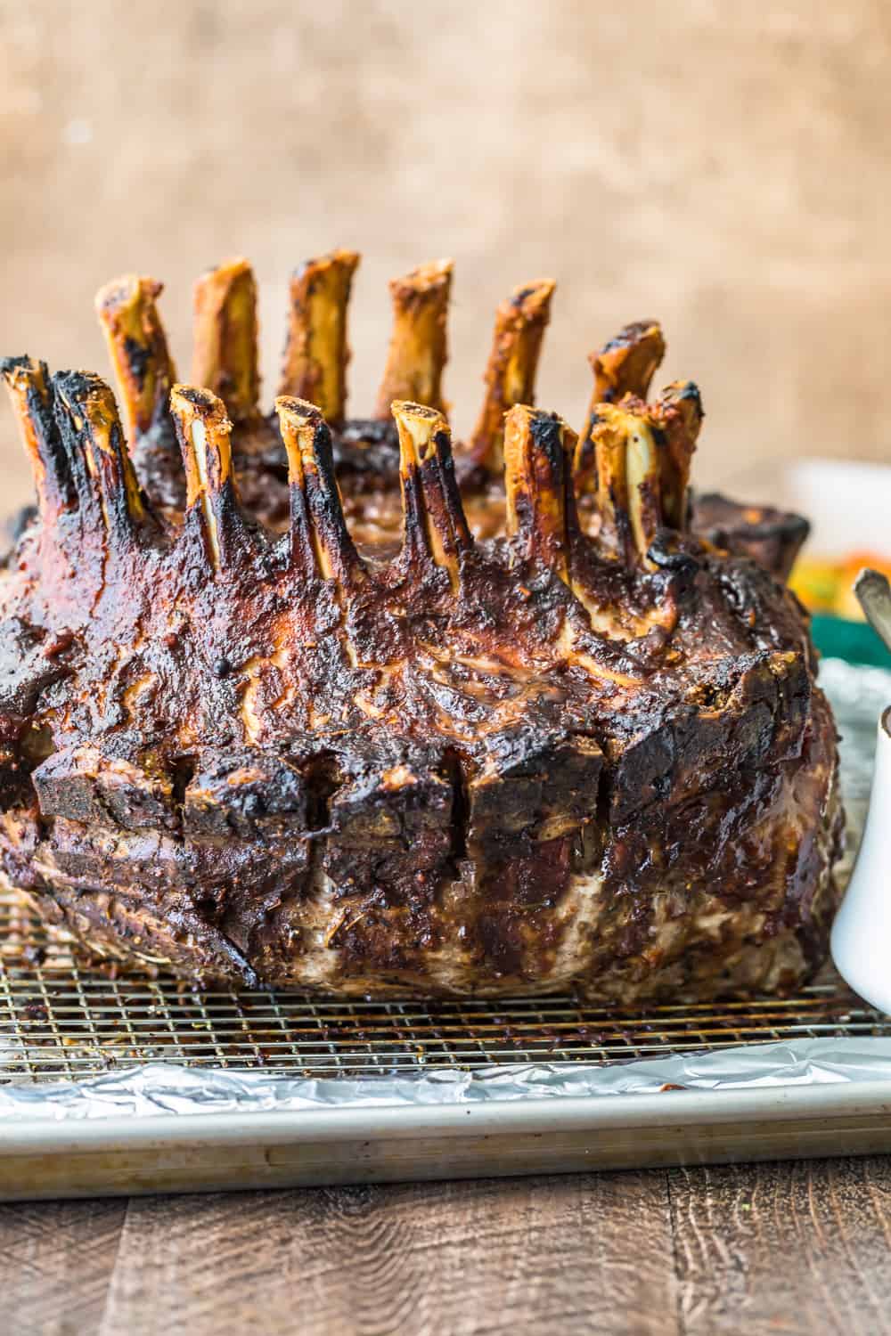 crown roast of pork resting on a cooling rack