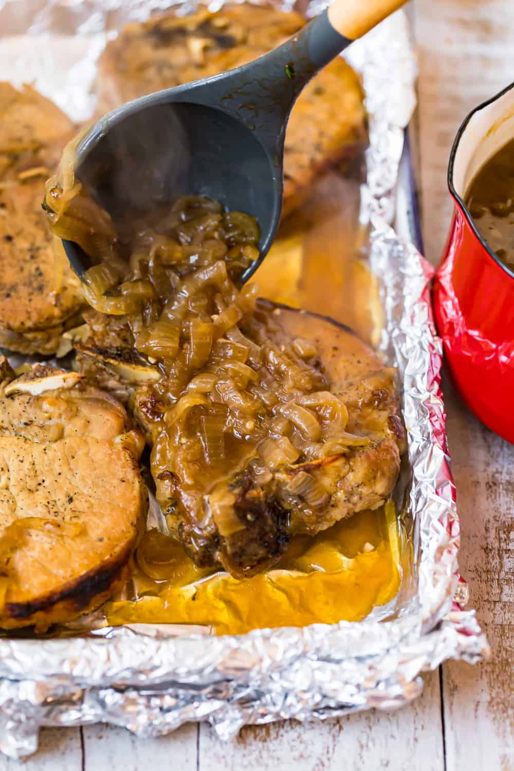 ladling sauce on crock pot smothered pork chops