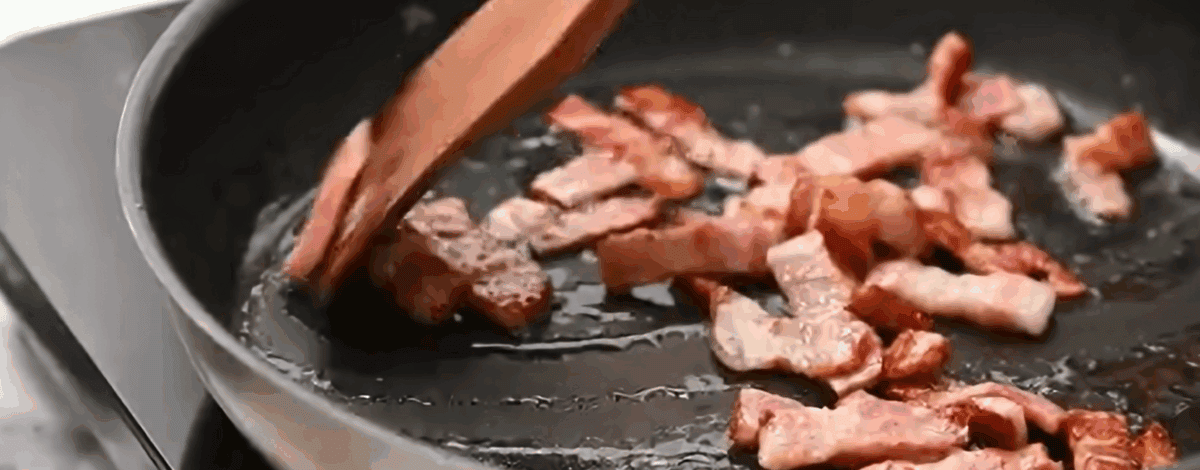 Cooking bacon in a skillet.