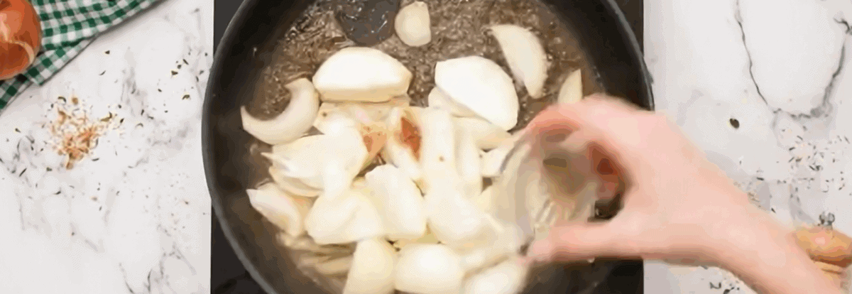 Cooking the onions and seasonings in the skillet.