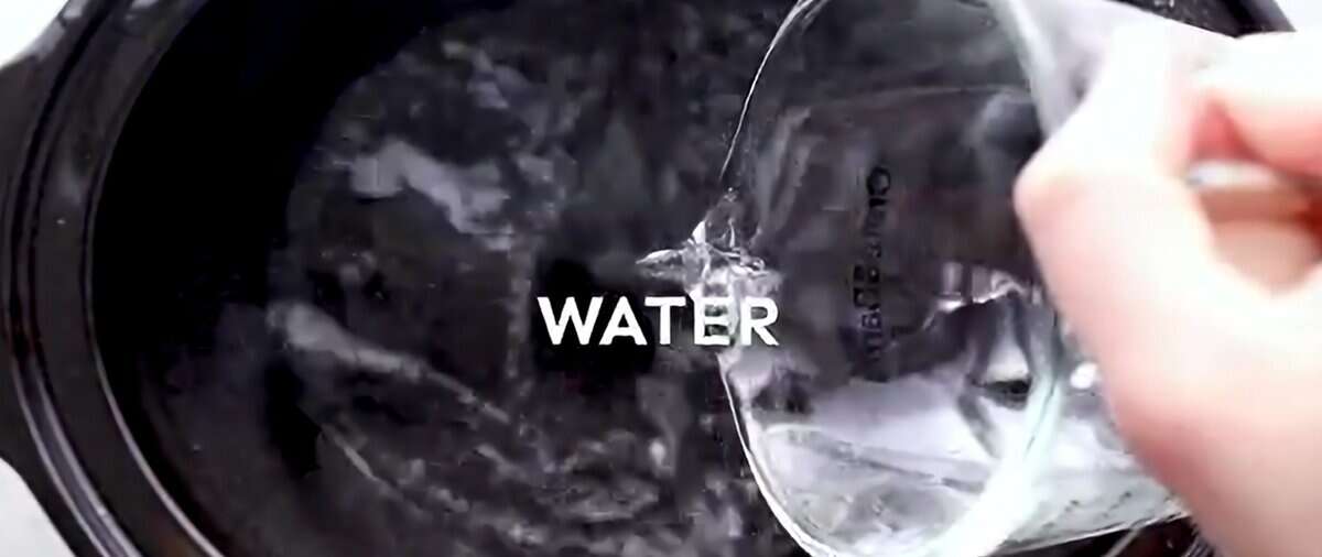 Pouring water into a crockpot. 