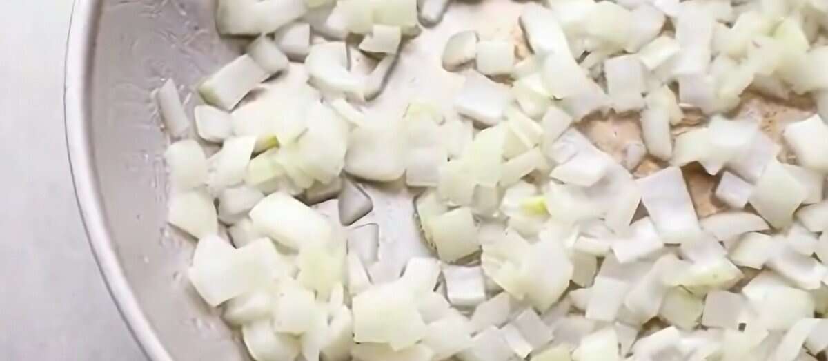 Cooking diced onions in a skillet.