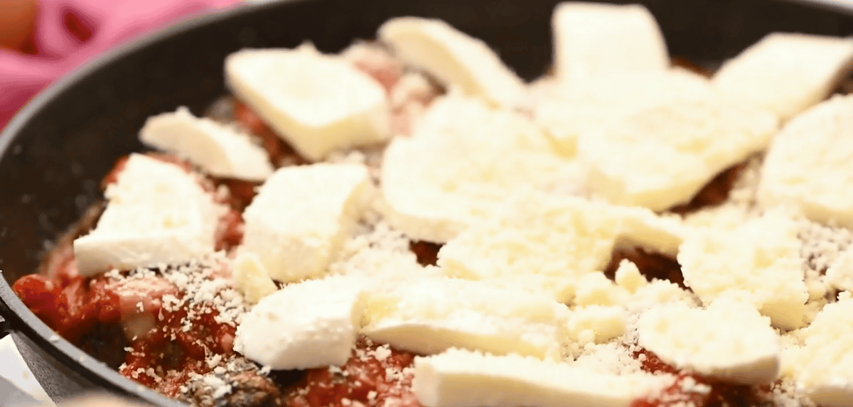 mozzarella slices on top of the meatballs. 