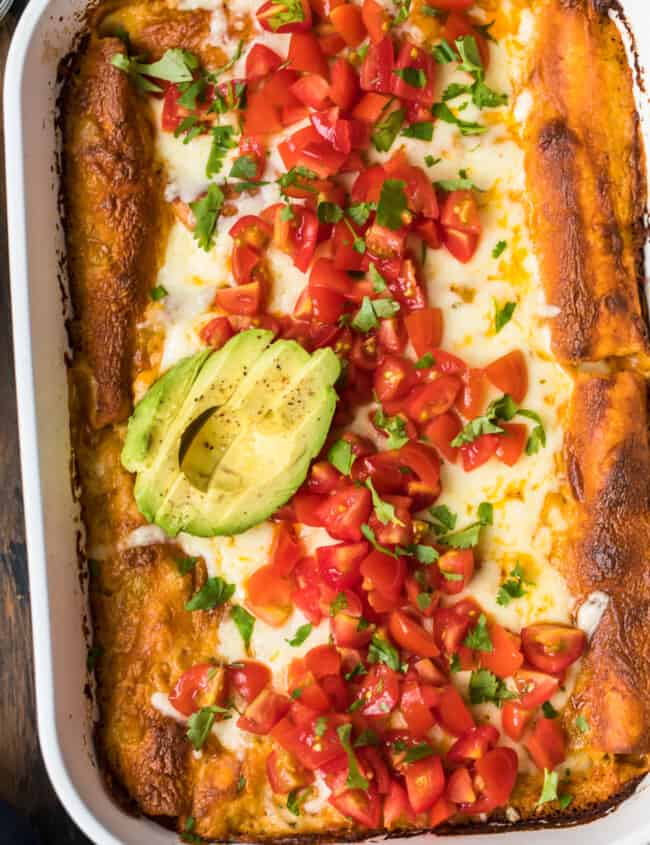 chicken enchiladas topped with avocado