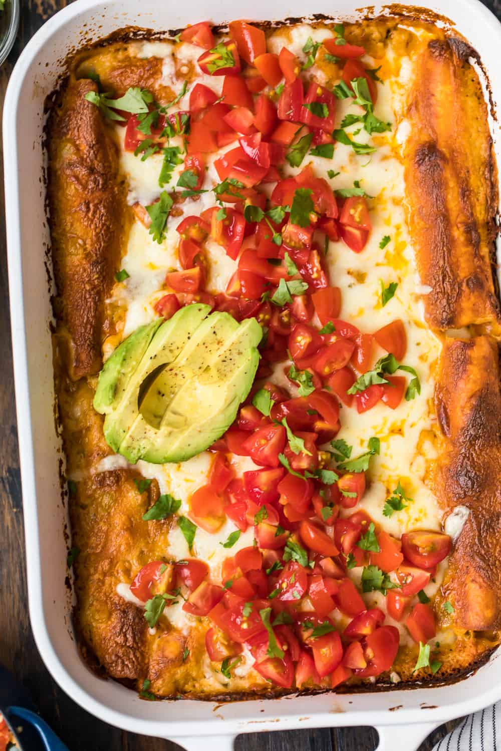 chicken enchiladas topped with avocado