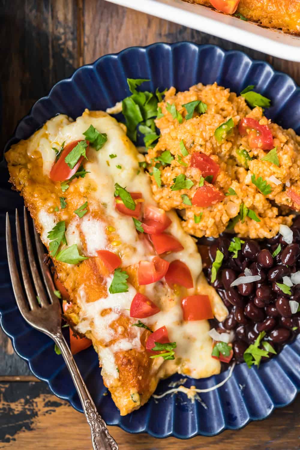 creamy chicken enchilada on plate with beans