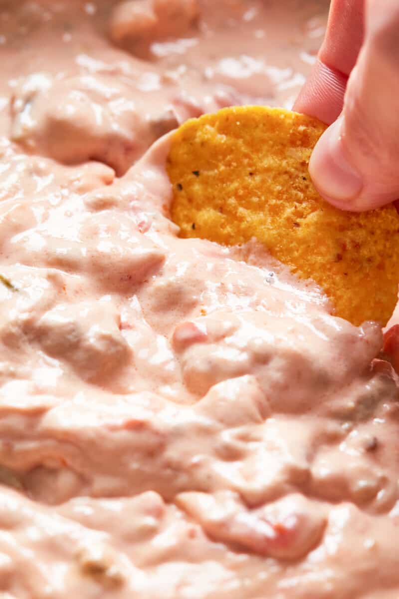 dipping chip into crockpot sausage cream cheese dip